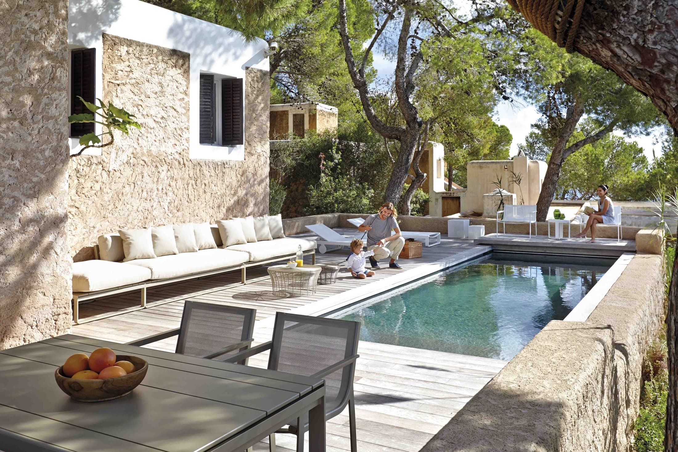 Flat Textil composition in white beside a stone pool.