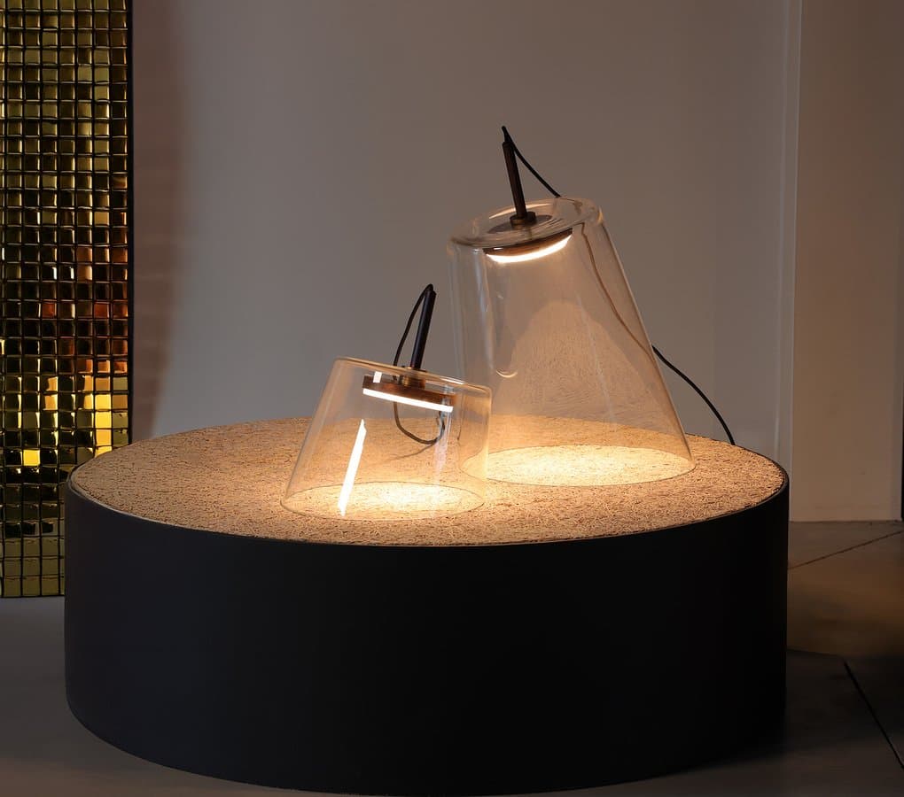 Fez blown-glass lamp glowing on a dark pedestal.