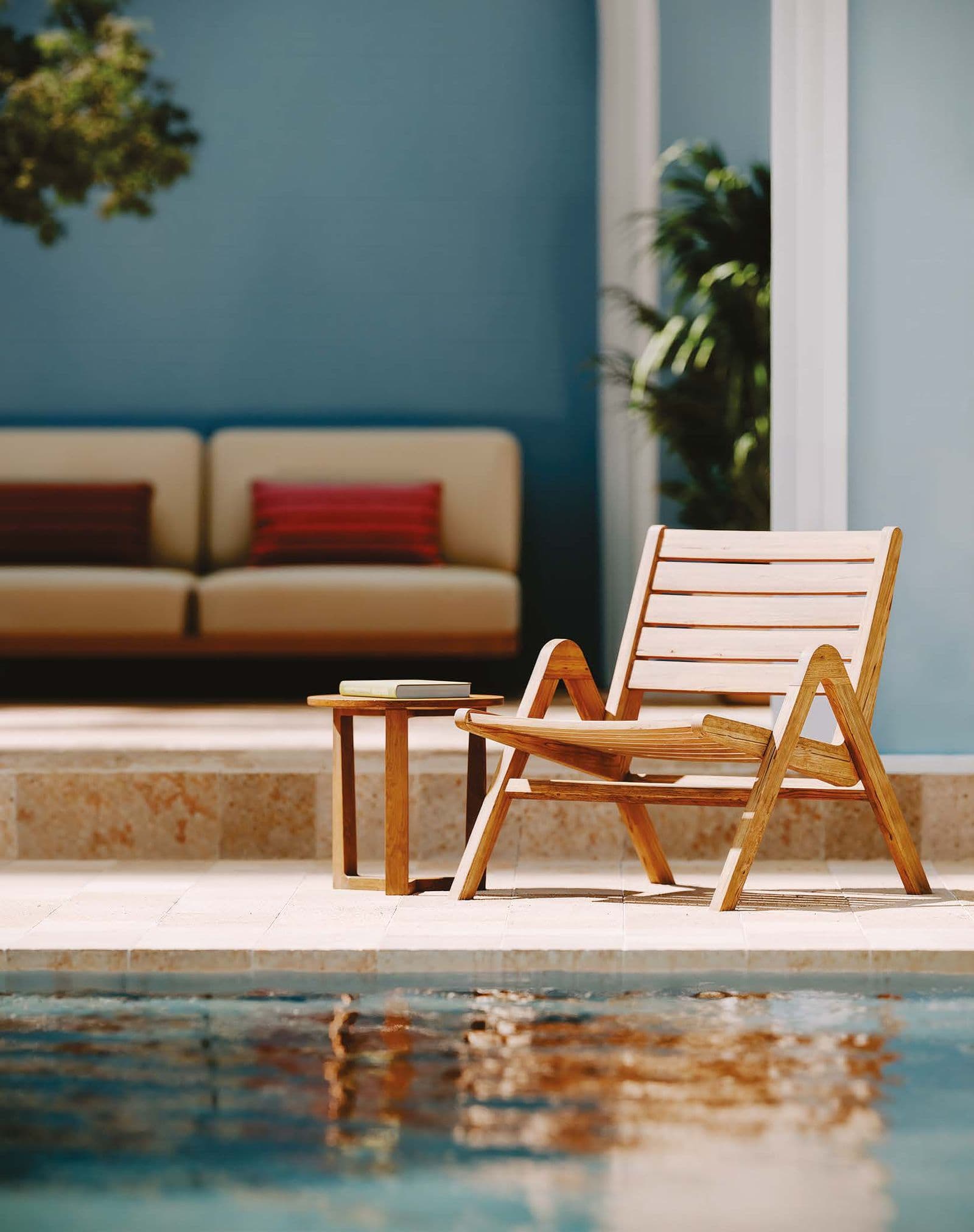 Positano rounded solid-teak table in the garden.
