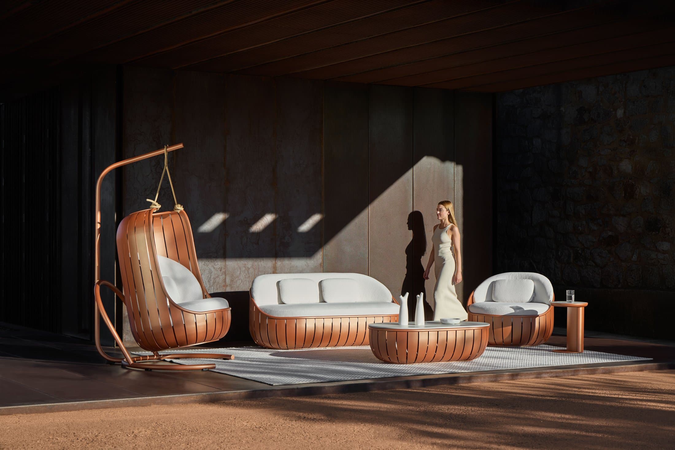 Arena composition in cuprum with hanging swing chair on a shaded terrace.