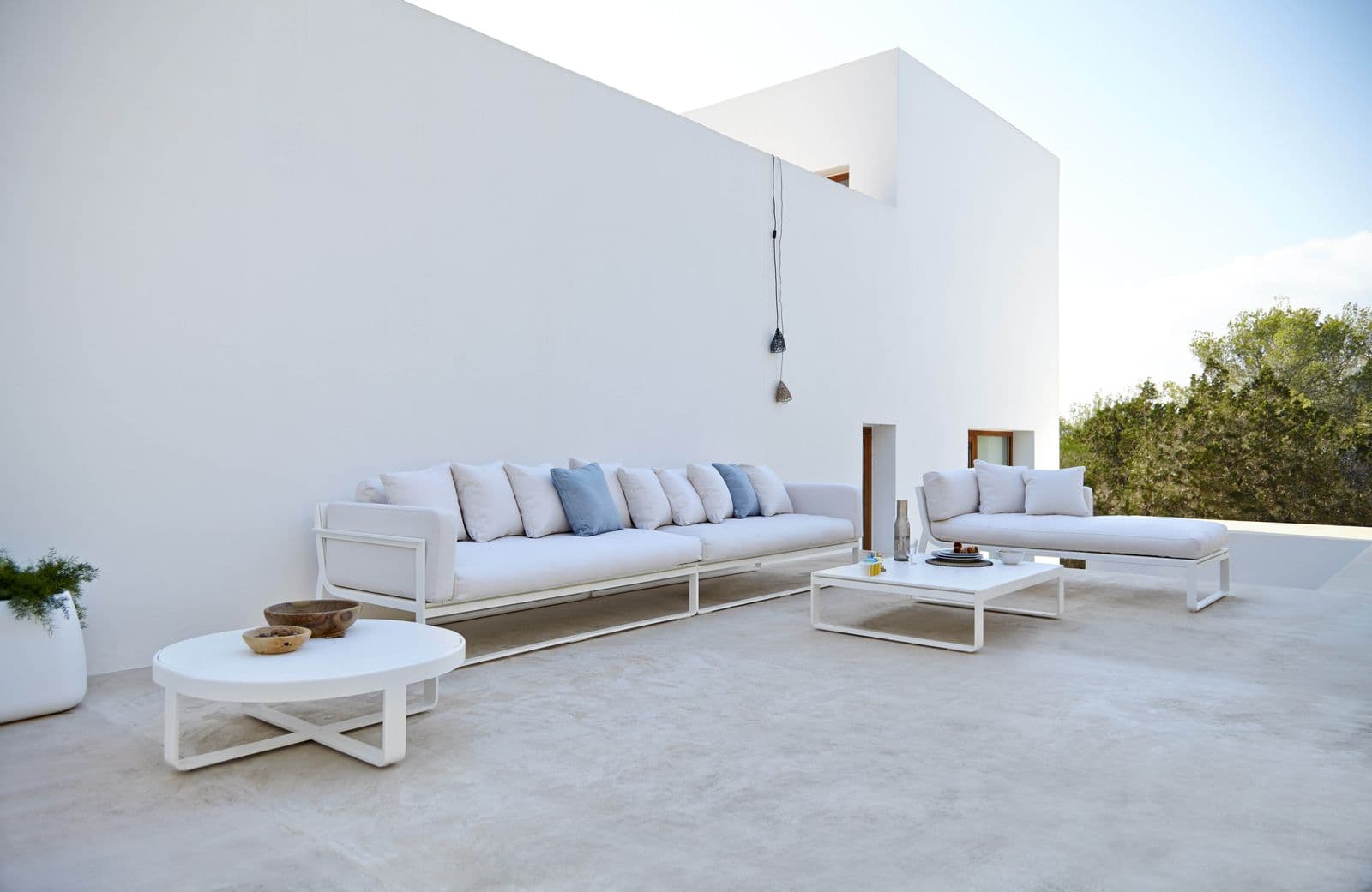 Flat sectionals and coffee tables in white.