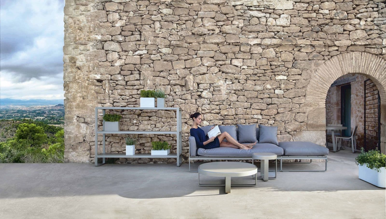 A Flat outdoor composition in sand on a Mediterranean terrace.