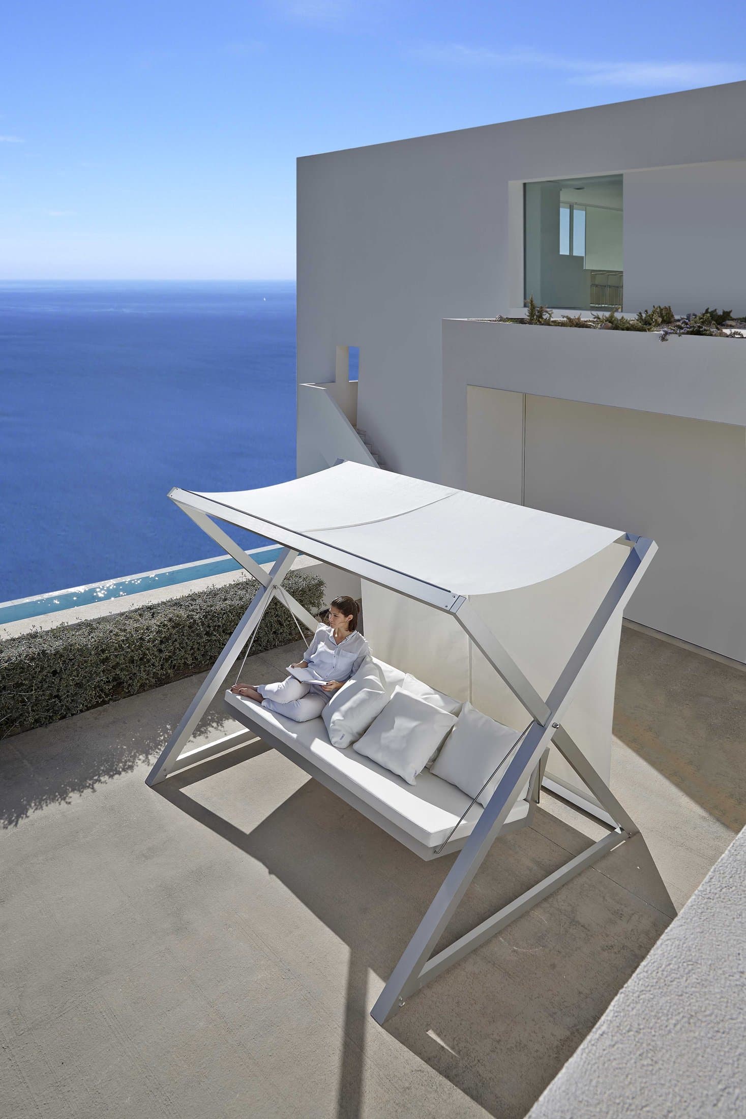 Nao Nao garden swing in white, canopy and woven seat.