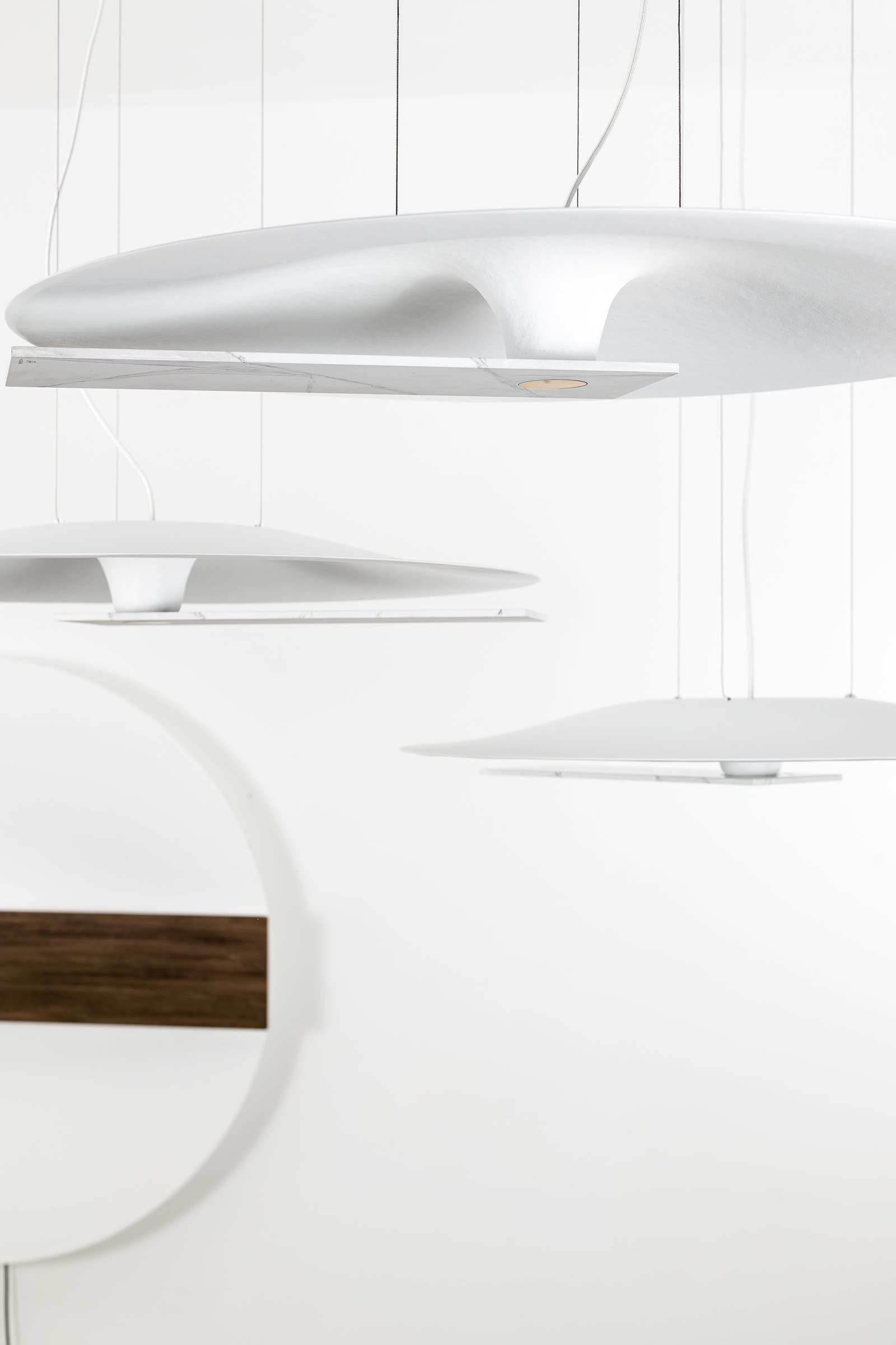 Meridiana disc suspended beside a blue armchair.