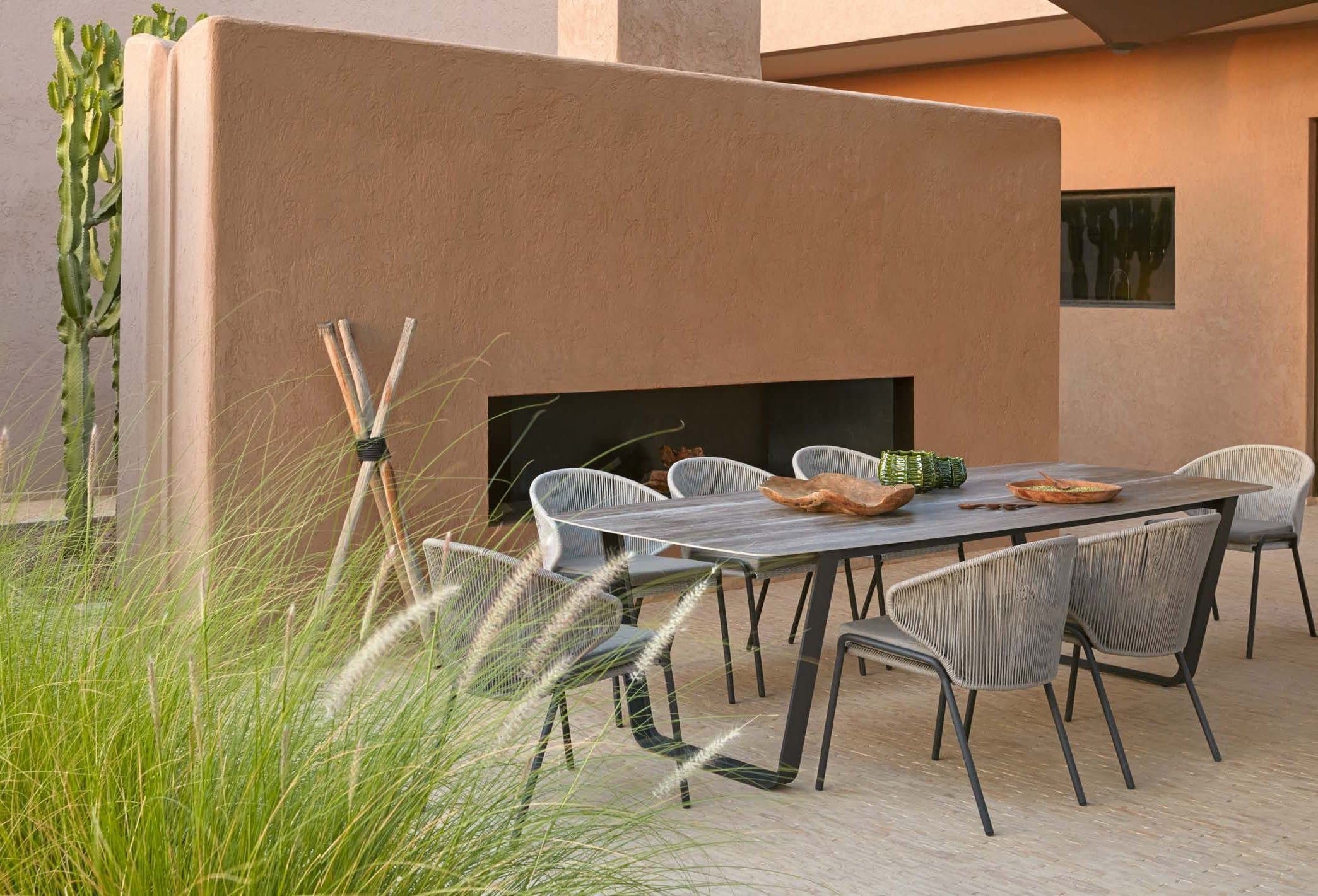 Manutti Air dining table on a minimal terrace.