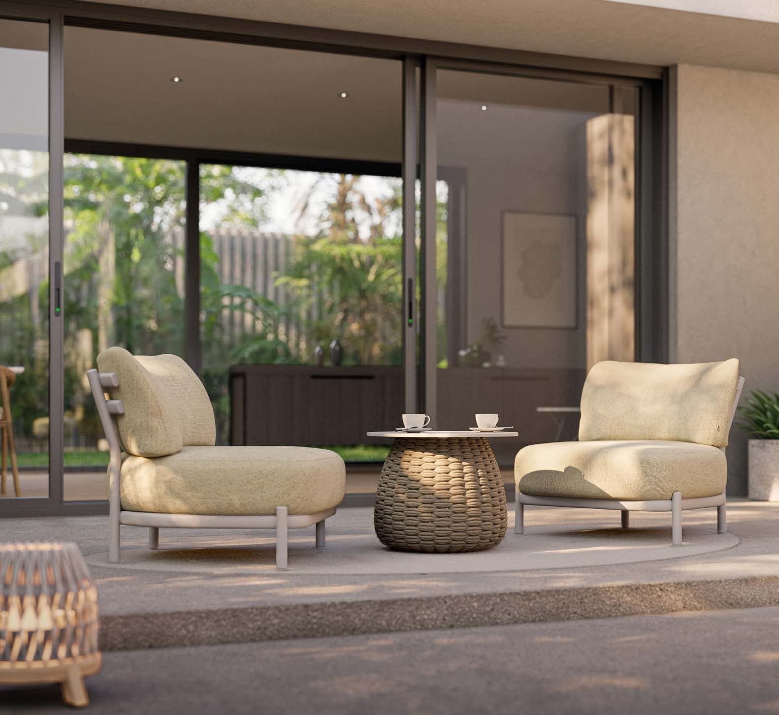 Manutti Alune lounge chairs with a Kobo coffee table on a stone terrace.