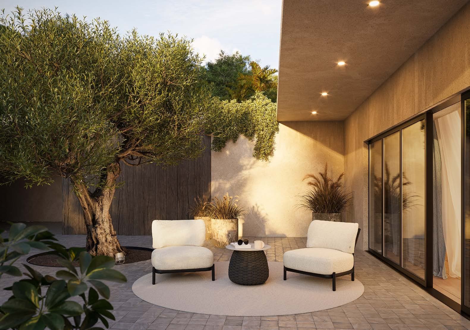 Alune lounge chair beside an evening fire bowl.