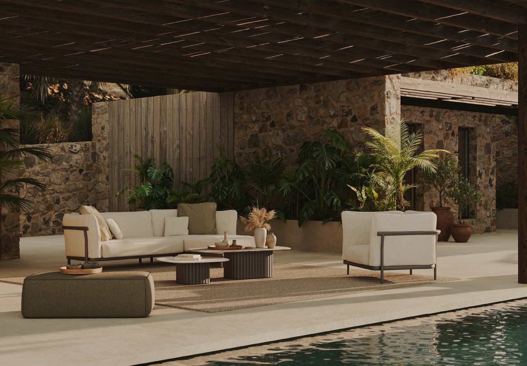 A Manutti Nami lounge in a shaded Mediterranean courtyard.