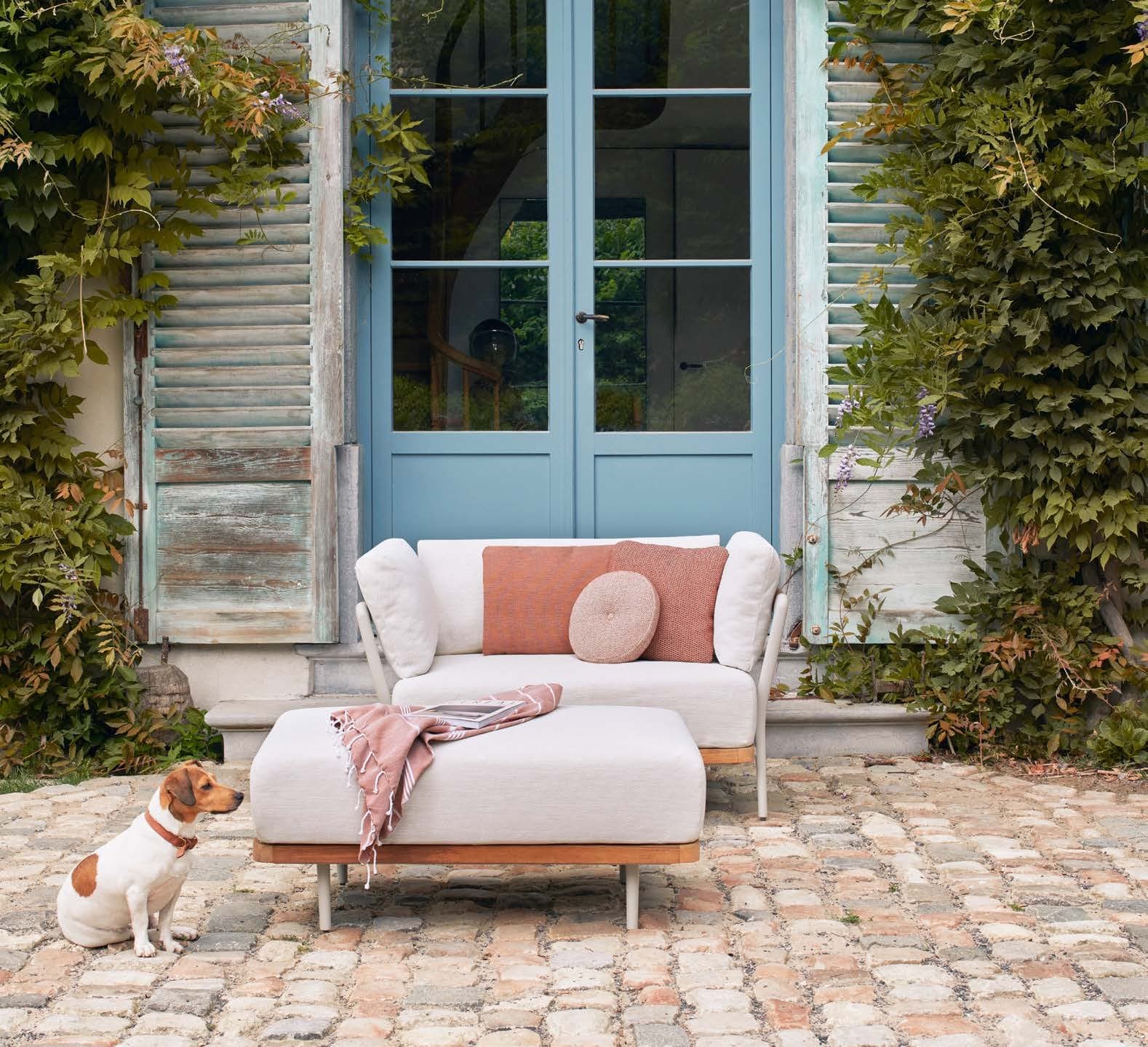 Flows lounge chair and footstool in a walled garden (Collections 2026).