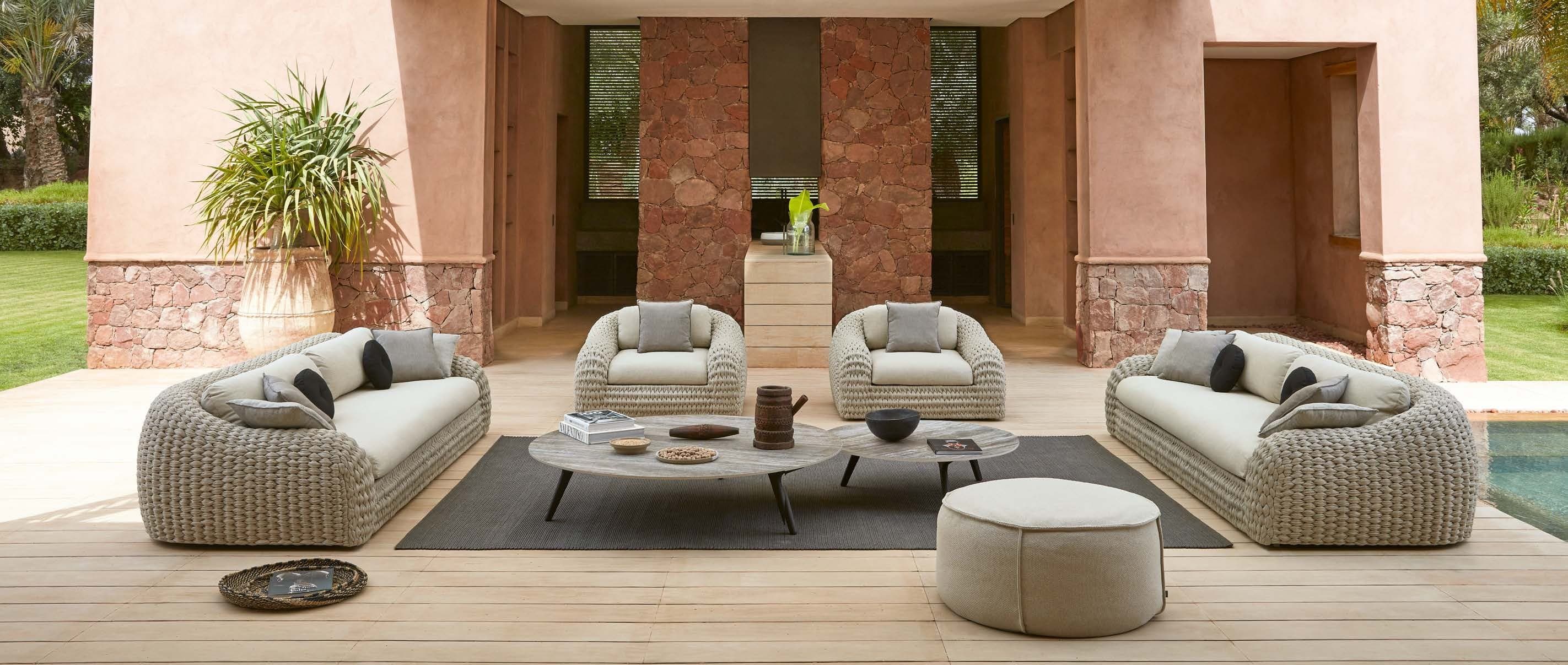 Manutti Kobo woven sofas against warm plaster walls.