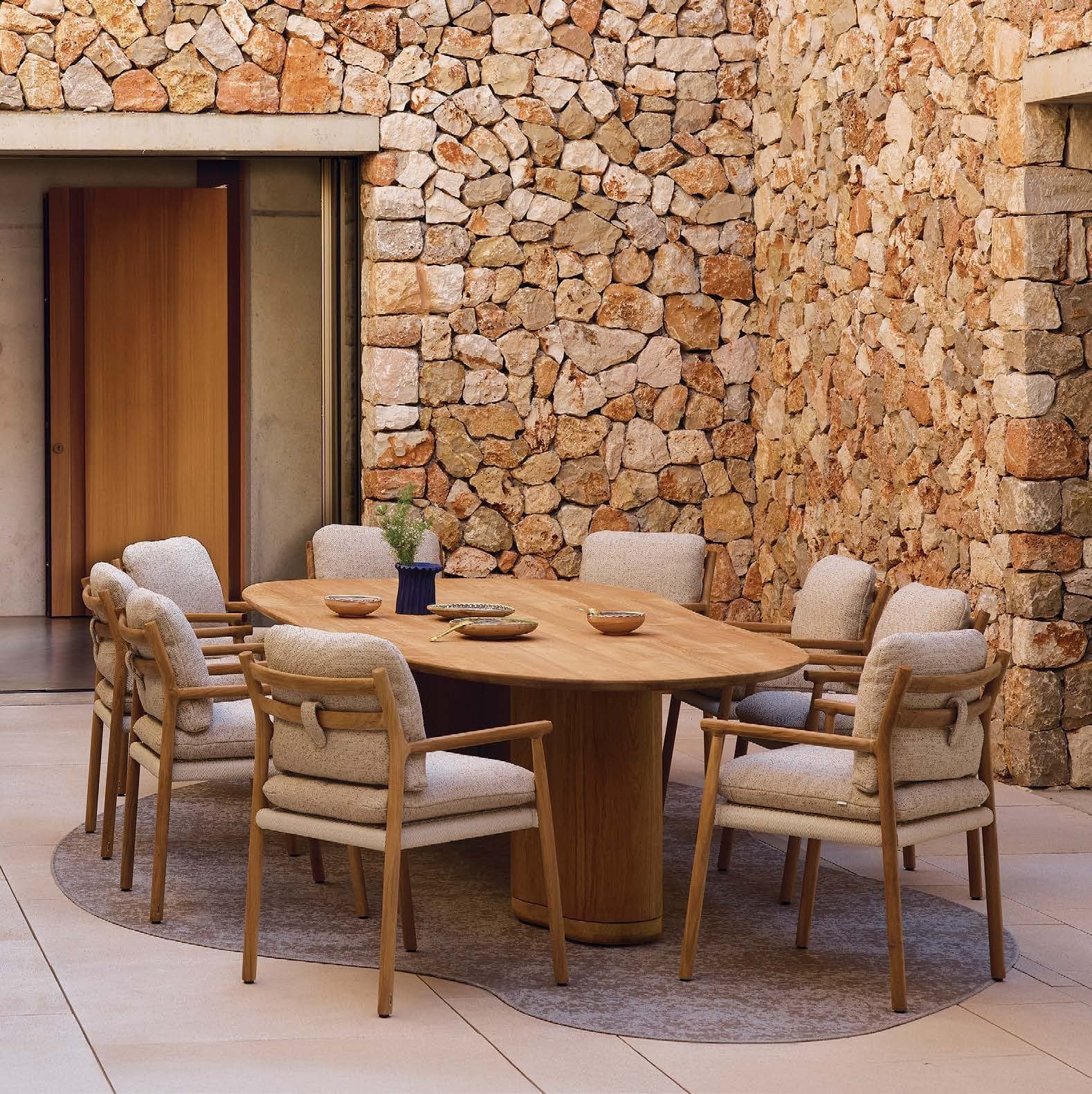 Muyu dining chairs around a round teak table.