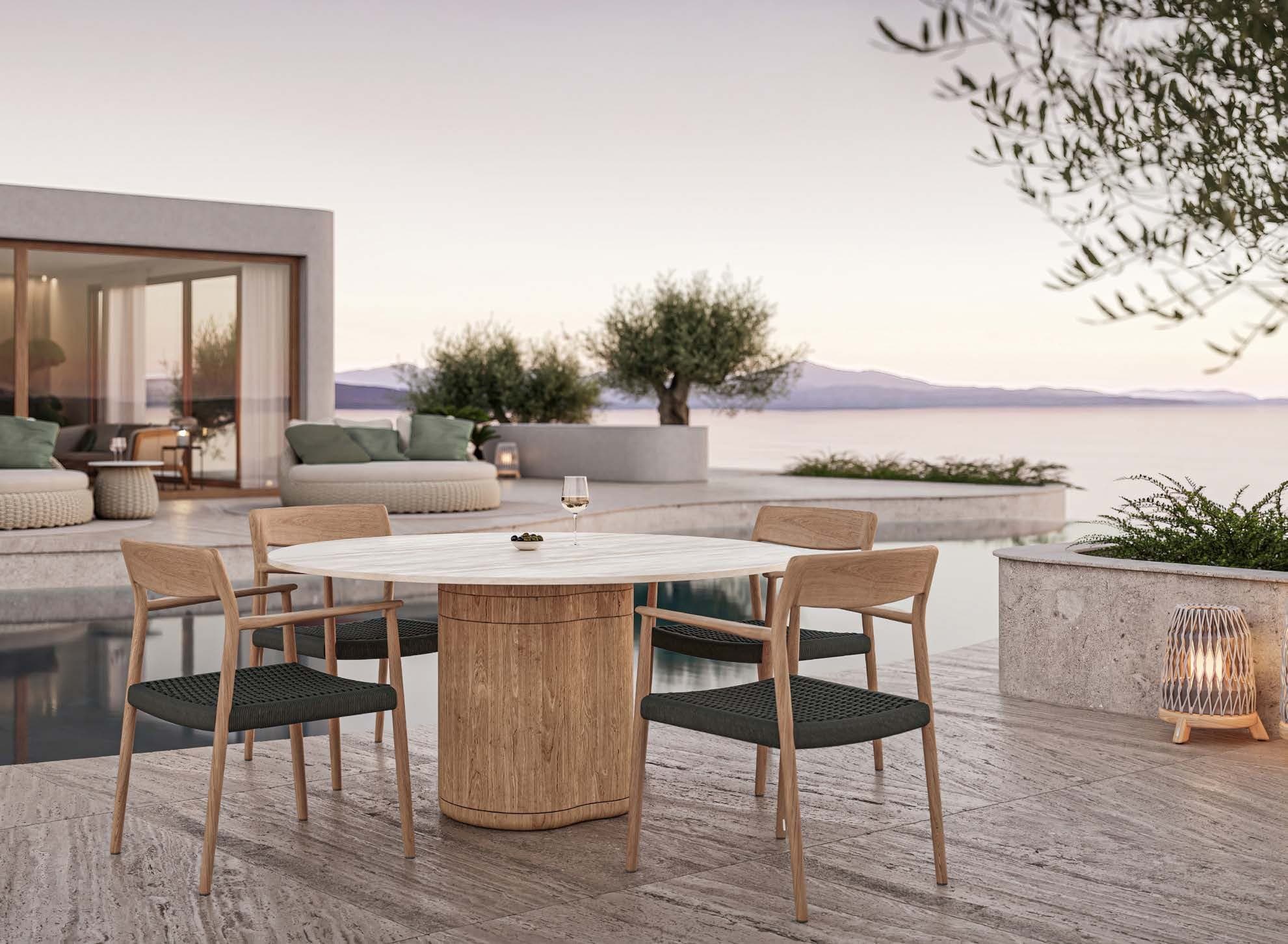 Manutti Tamo chairs around an Ogado dining table by the sea.