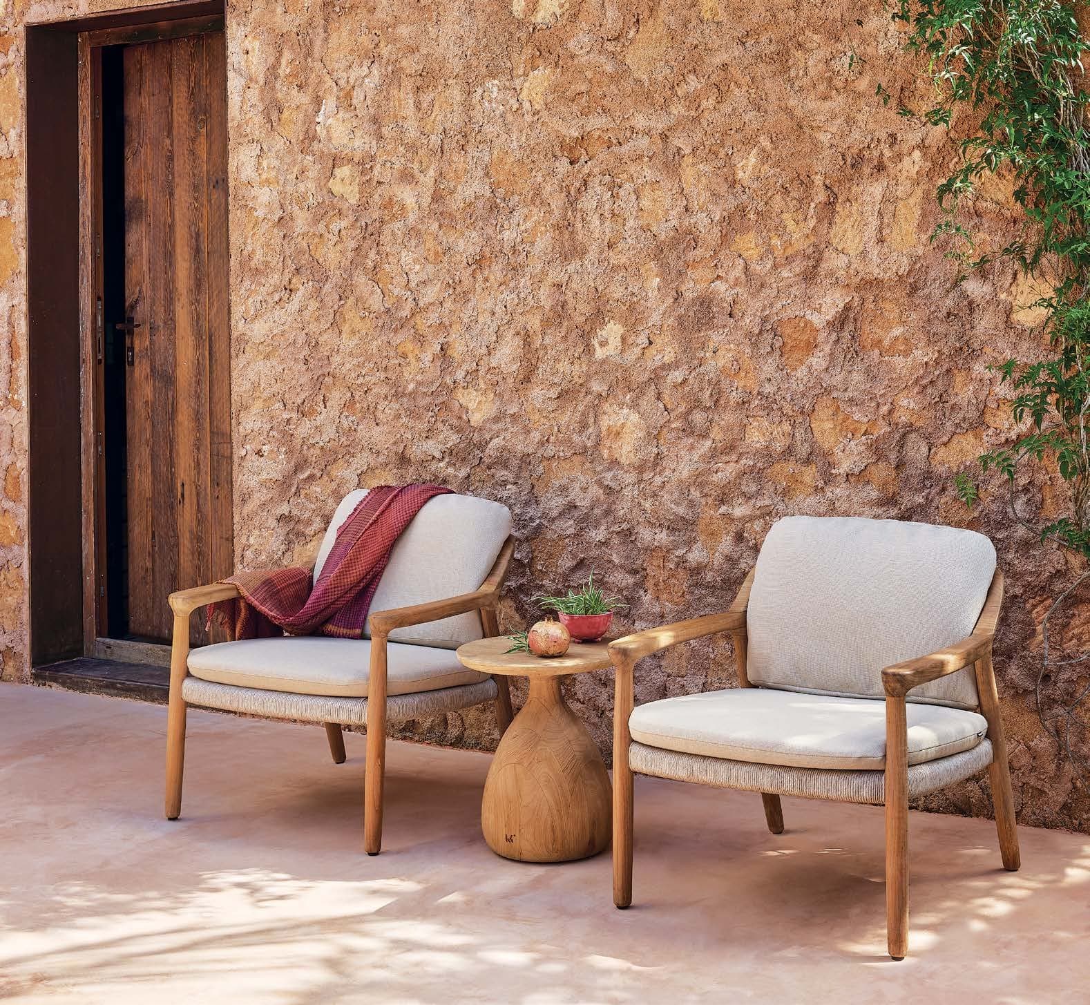 Manutti Yiko lounge chairs against a warm plaster wall.