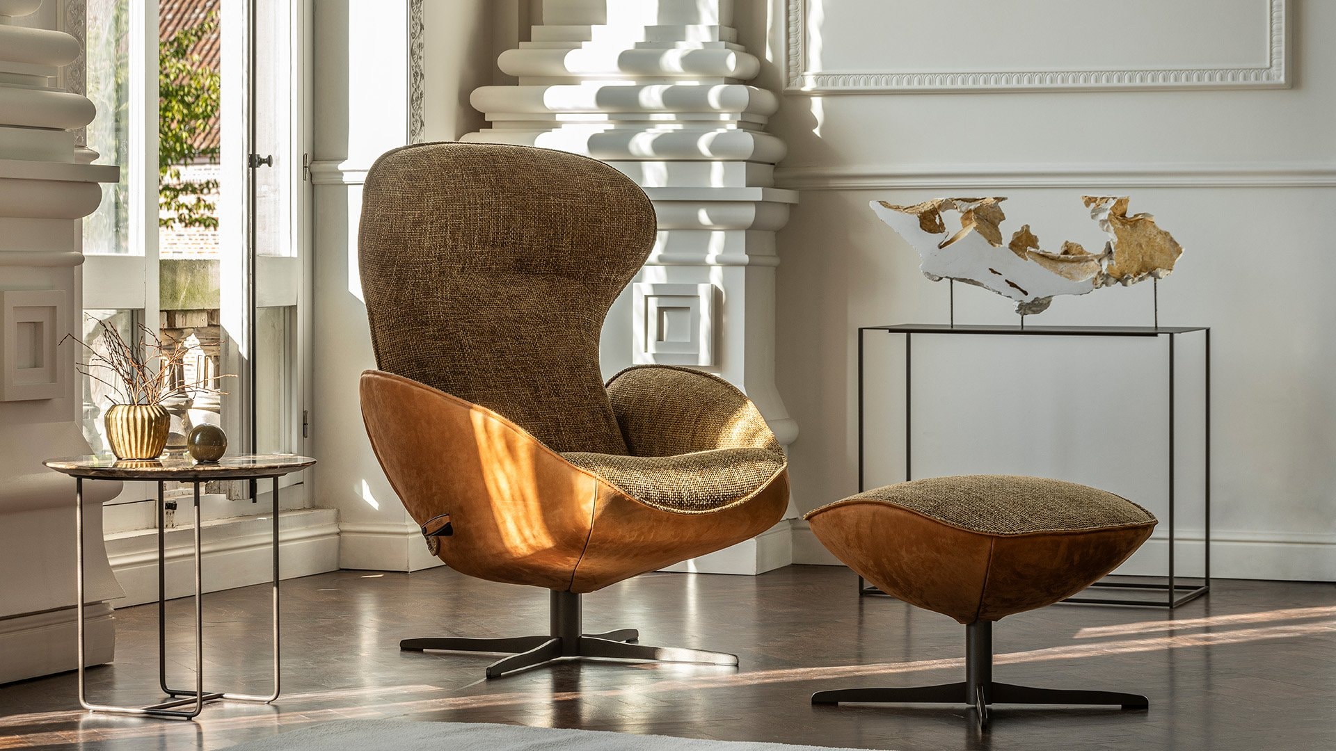 Jori Daydreamer leather lounge chair and ottoman in a sunlit room.