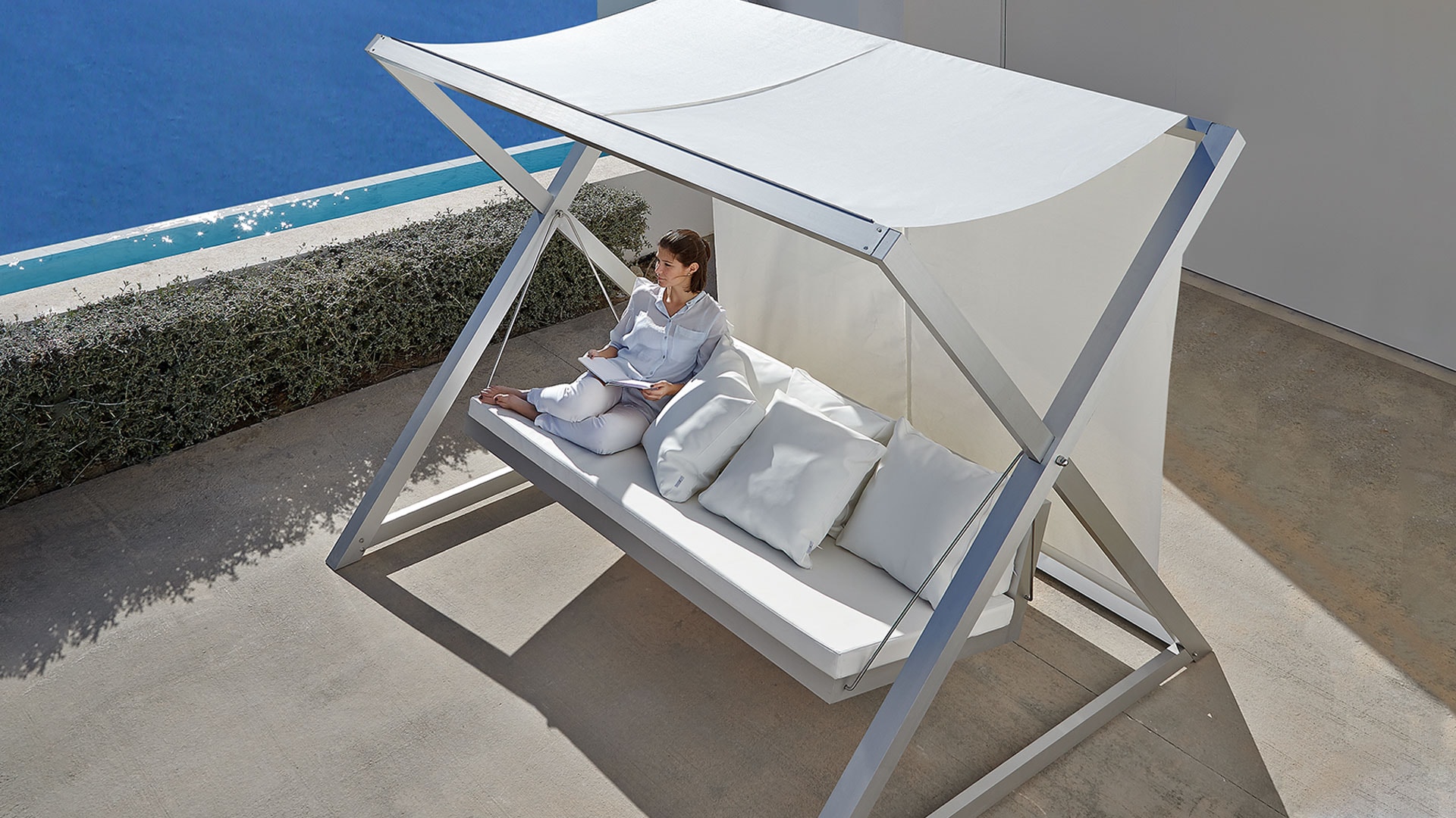 Gandiablasco Nao Nao swing seat on a terrace above the sea.