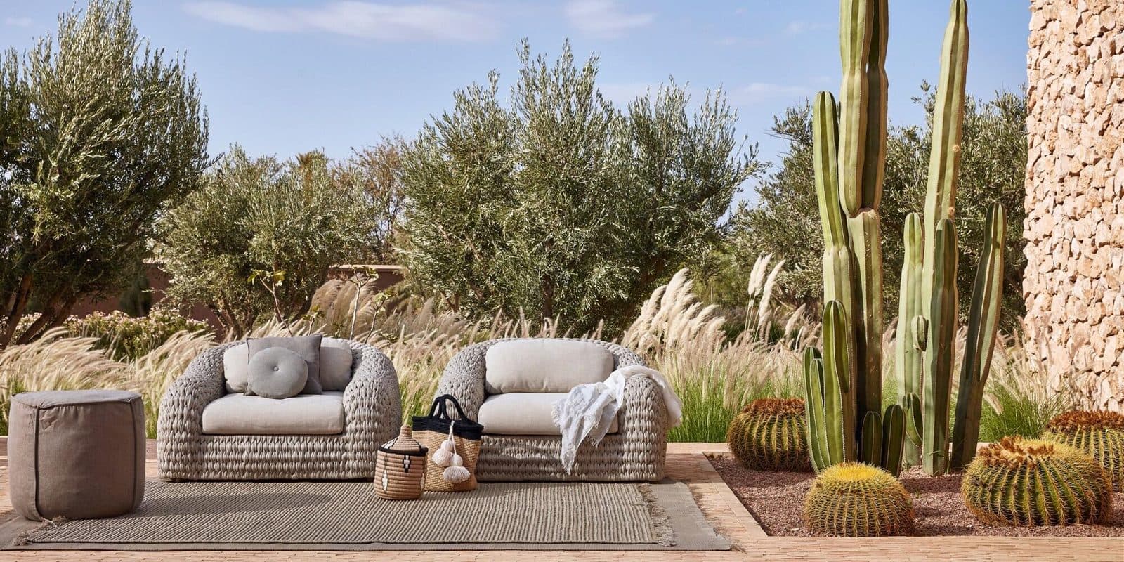 A refined outdoor lounge and dining setting at dusk.